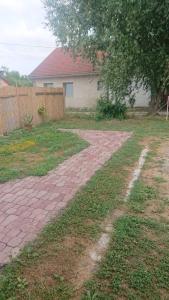 a brick driveway in a yard with a house at Majorka in Balatonfenyves