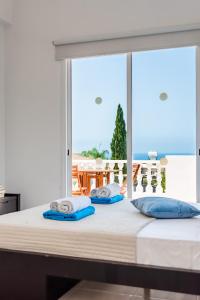 a bedroom with a bed with a view of the ocean at Villa Alysia by Ezoria Villas in Coral Bay