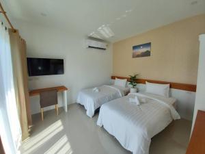 Postel nebo postele na pokoji v ubytování Pure Laguna Residence by Nice Sea Resort