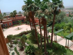 an overhead view of a courtyard with palm trees at Kenzi Azghor in Ouarzazate