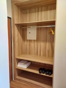 a walk in closet with wood paneling and a pair of shoes at Otter Hotel in Jinhu