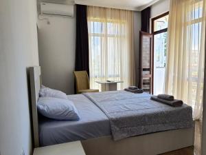 a bedroom with a bed and a large window at Hotel Edelweiss in Ureki