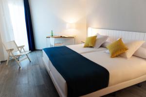Säng eller sängar i ett rum på Hotel Agaró