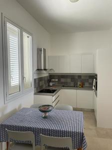 a kitchen with a table and chairs and a table and a table and chairsktop at Villa Linda on the sea in Siracusa