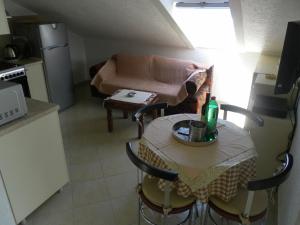 a small kitchen with a table with a bottle on it at Apartments David in Perast