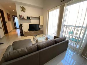 a living room with a couch and a television at Viewpoint in St. Julianʼs