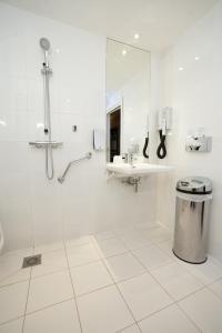 a bathroom with a sink, toilet and shower stall at Holiday Inn Express Strasbourg - Sud, an IHG Hotel in Geispolsheim