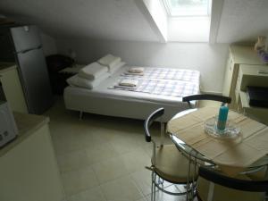 a small room with a bed and a table at Apartments David in Perast