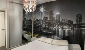 a bedroom with a black and white picture of a city at Tunel10 in Zamora