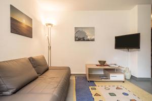 a living room with a couch and a tv at Haus Afaldra in Mengen