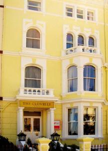 a yellow building with a sign in front of it at The Clovelly in Llandudno