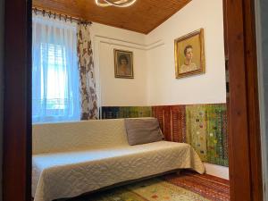 a bedroom with a bed and a window at Tiszavirág Vendégház in Abádszalók