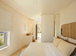 Posteľ alebo postele v izbe v ubytovaní White Pebble Suites