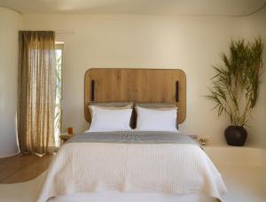 Posteľ alebo postele v izbe v ubytovaní White Pebble Suites