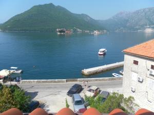 a view of a lake with a boat in the water at Apartments David in Perast
