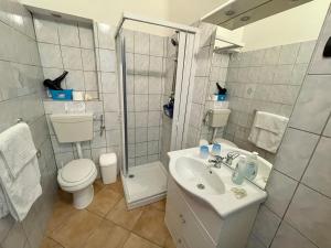 a bathroom with a toilet and a sink and a shower at B&B Scala dei Turchi Beach in Realmonte