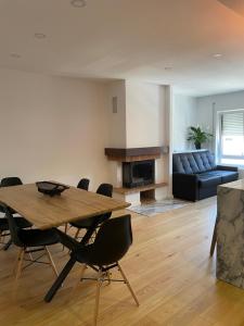 a living room with a table and chairs and a couch at Casa da Sofia in Leça da Palmeira