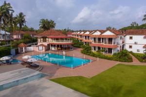 an aerial view of a house with a swimming pool at Nanu Beach Resort & Spa in Betalbatim