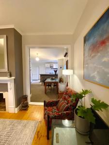 a living room with a couch and a table at Loose Leaf Cottage in Kyneton