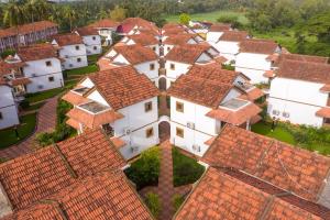 an aerial view of a large group of houses with red roofs at Nanu Beach Resort & Spa in Betalbatim