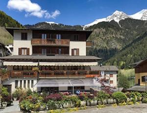 a large building in front of a mountain at Albergo Ristorante Sole in Mezzoldo