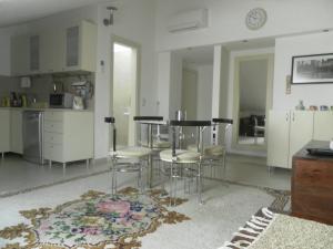 a kitchen with a table and stools in a room at Apartments David in Perast