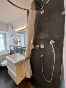 a bathroom with a shower and a sink at Paleo Finest Serviced Apartments in Munich