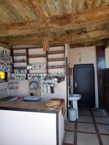 a kitchen with a counter with a sink and a toilet at Kelany Hotel in ‘Izbat Zaydān