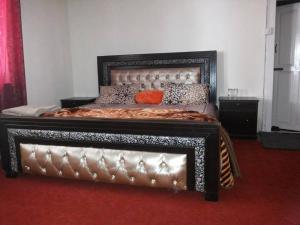 a large bed with a leather frame in a room at Hotel Kashmir Lodge in Bālak Bhanna