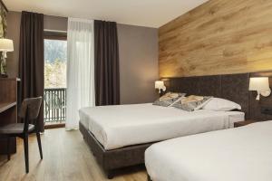 Postel nebo postele na pokoji v ubytování Hotel Canin