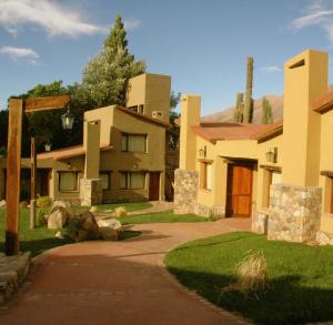 a large house with a driveway in front of it at Hotel El Reposo Del Diablo in Tilcara