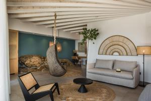 a living room with a couch and a chair at Amyth of Mykonos Super Paradise in Super Paradise Beach