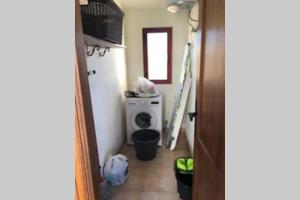a small bathroom with a washing machine in a room at CASA RURAL MAMÁ in Taibique +12 photos