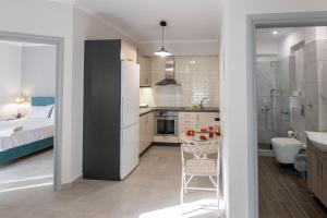 a kitchen with a sink and a bathroom with a bed at Elite City Apartments & Maisonettes in Lefkada +108 photos