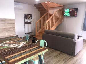 a living room with a table and a couch at Casa el Elefante Blanco in Cabárceno