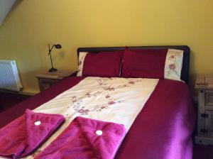 A bed or beds in a room at The Old Forge B&B 