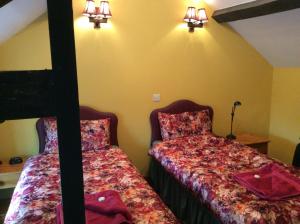 A bed or beds in a room at The Old Forge B&B 