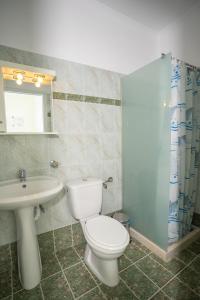 a bathroom with a white toilet and a sink at Ionian Melody in Nikiana