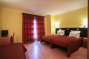 Uma cama ou camas num quarto em Hospedaria Robalo