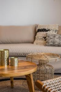 a living room with a couch and a coffee table at Amyth of Mykonos Super Paradise in Super Paradise Beach