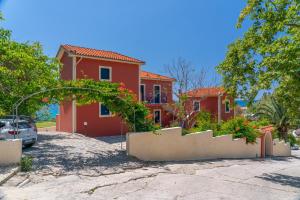 a house with a car parked in front of it at Aloe Studios, Waterfront Accommodation in Karavádhos