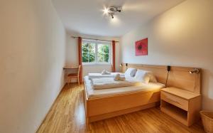 a bedroom with a bed and a window at Appartement Iglsberg Top 2 in Saalbach-Hinterglemm