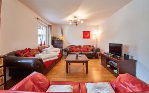 a living room with two couches and a tv at Appartement Iglsberg Top 2 in Saalbach-Hinterglemm
