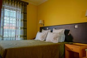 Uma cama ou camas num quarto em Hospedaria Robalo