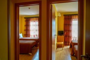 Uma cama ou camas num quarto em Hospedaria Robalo