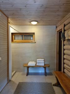 a sauna room with a bench and a window at Rasos Vila in Palanga