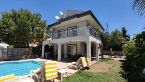 a villa with a swimming pool and a house at Villa Jasmin in Fethiye
