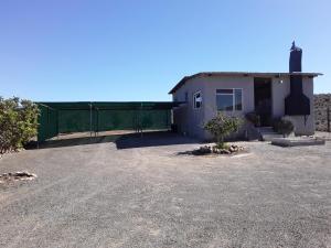a building with a fence in front of it at Eltos Karoo Stay Guest Farm in Laingsburg