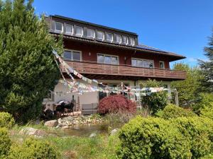 a house with a bunch of flags in front of it at Landhaus Bukenberger in Freudenstadt