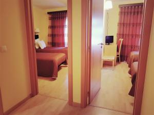 Uma cama ou camas num quarto em Hospedaria Robalo